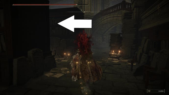 A warrior walks through some tall bookcases in Elden Ring Shadow of the Erdtree, with a white arrow angled left, showing the direction where Ansbach is located.