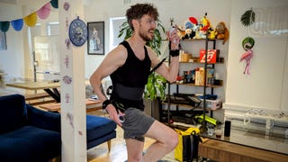 A photo of Bertie in a vest and shorts with a fitness gaming device strapped around his waist and arms. It's called Quell. Bertie is smiling and has a visible t-shirt tan.